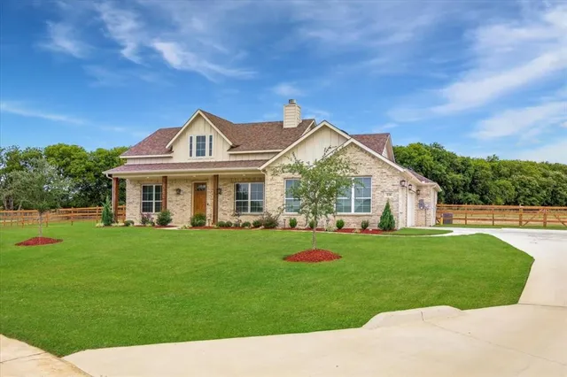 a front view of a house with a yard table and chairs