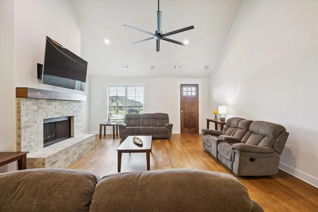 a living room with furniture a flat screen tv and a fireplace