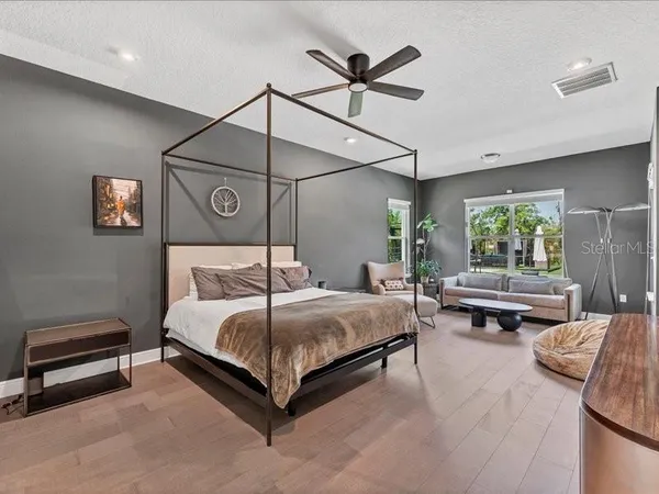 a bedroom with a bed and a chandelier