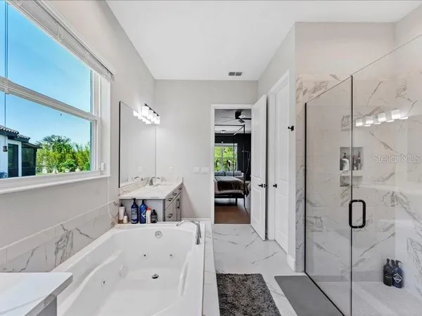 a bathroom with a tub sink and mirror