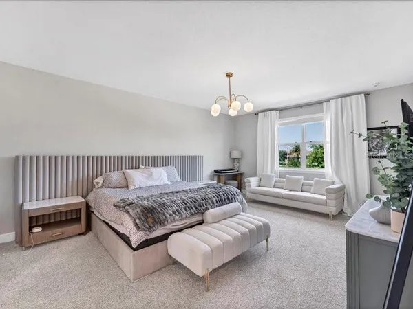 a spacious bedroom with a bed and a couch