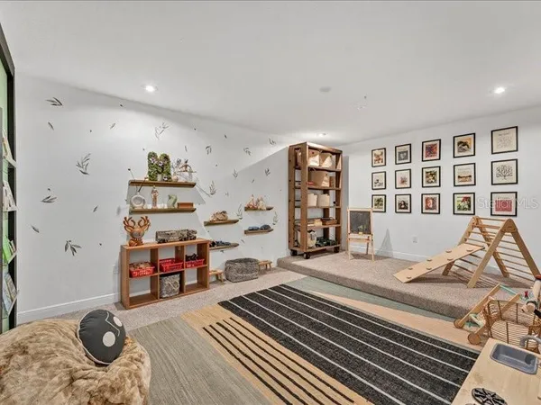 a living room with furniture cabinets and wooden floor