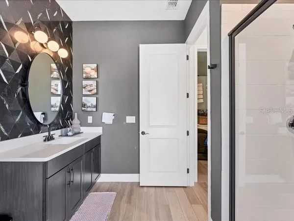 a bathroom with a sink vanity and a mirror
