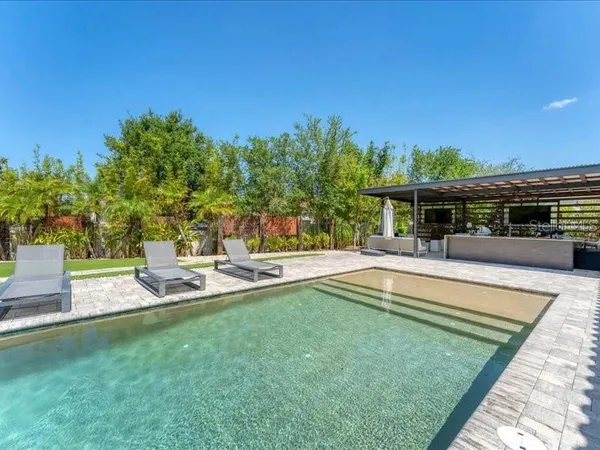 a view of a house with swimming pool and sitting area