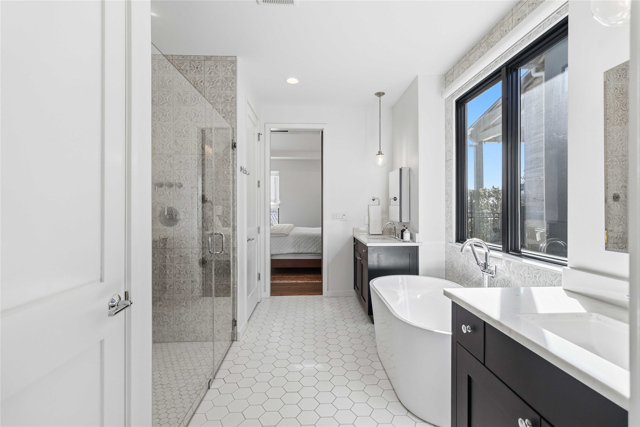 410 Kayak Way Austin, TX 78738 - Photo 18 of 39 Ensuite bathroom with a freestanding tub, a shower stall, two vanities, and recessed lighting