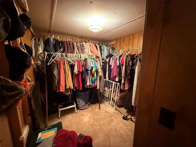a view of walk in closet with clothes