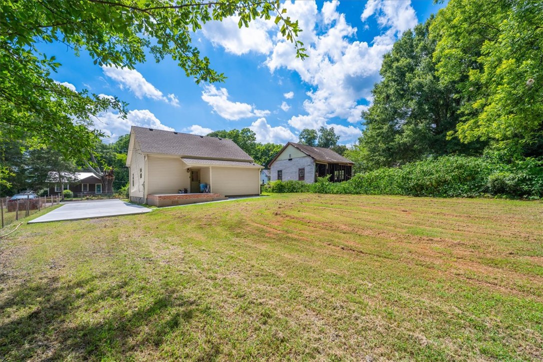 1102 West End Avenue Anderson, SC 29625 - Photo 27 of 28 A spacious backyard with mature trees providing a lush, private setting.