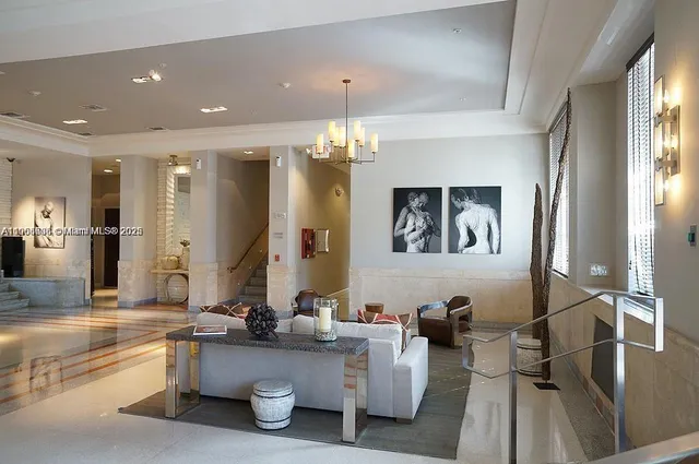 a living room with furniture and a chandelier