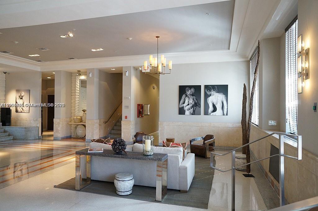 435 21st Street, Unit 215 Miami Beach, FL 33139 - Photo 1 of 14 a living room with furniture and a chandelier