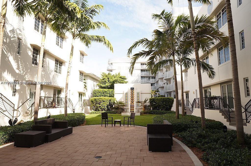 435 21st Street, Unit 215 Miami Beach, FL 33139 - Photo 12 of 14 a view of a patio with a table and chairs