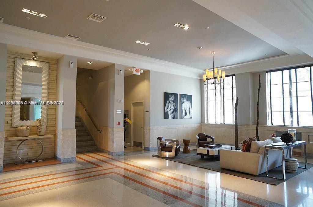 435 21st Street, Unit 215 Miami Beach, FL 33139 - Photo 13 of 14 a living room with furniture and a window