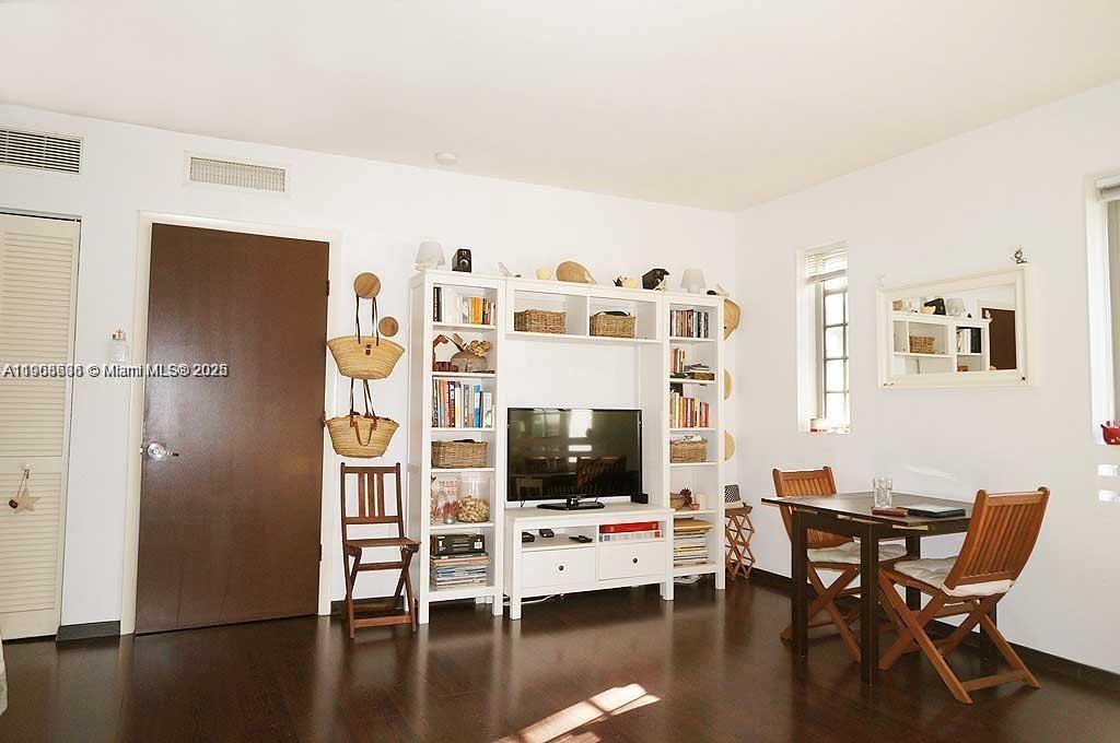435 21st Street, Unit 215 Miami Beach, FL 33139 - Photo 4 of 14 a living room with furniture and a flat screen tv