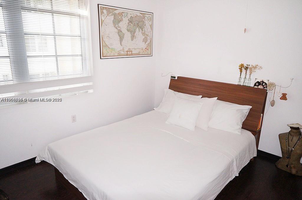435 21st Street, Unit 215 Miami Beach, FL 33139 - Photo 6 of 14 a large bed sitting in a bedroom next to a window