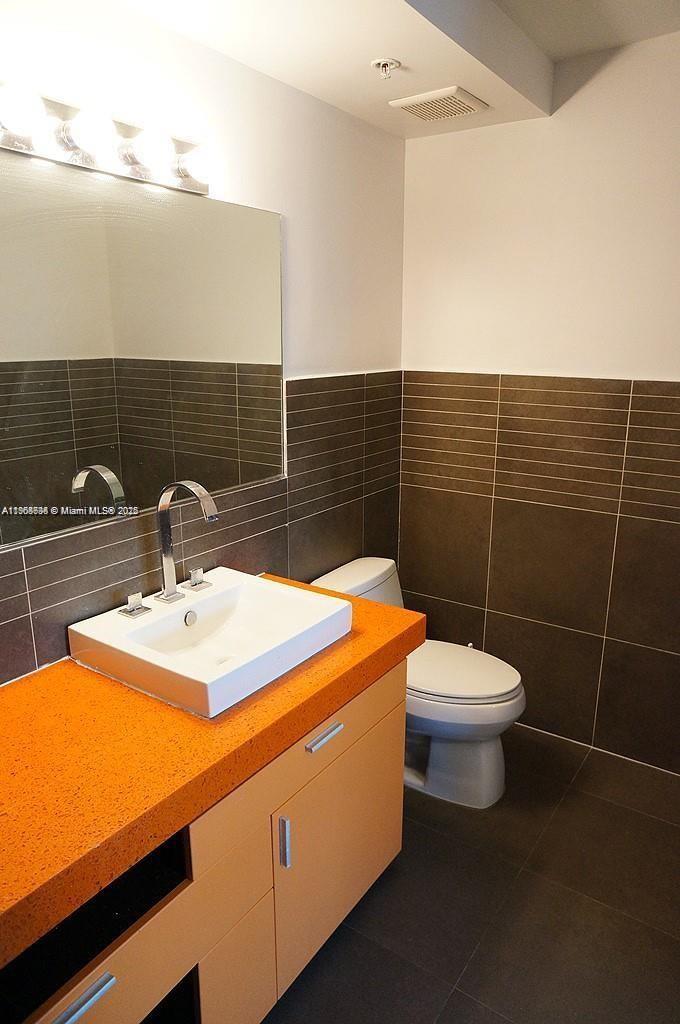 435 21st Street, Unit 215 Miami Beach, FL 33139 - Photo 7 of 14 a bathroom with a sink and toilet