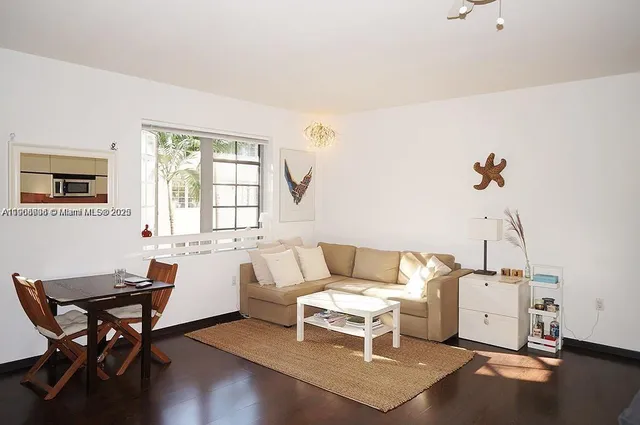 a living room with furniture a window and a table