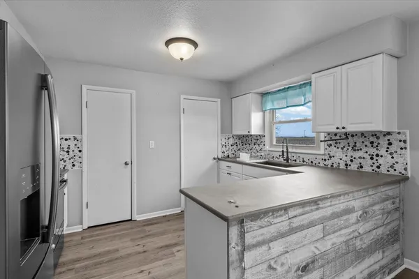 a kitchen with a sink appliances and cabinets