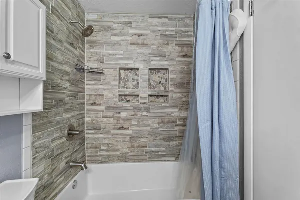 a bathroom with a shower and a toilet