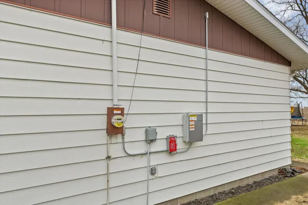 a backyard of a house with table and chairs