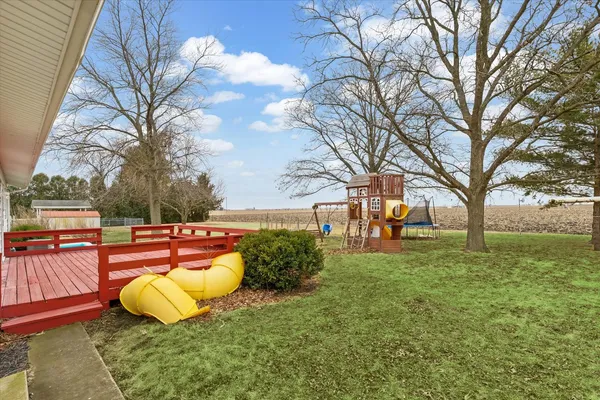 a view of a house with a backyard and porch