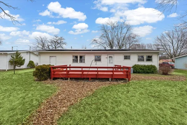 a view of a house with a yard table and chairs