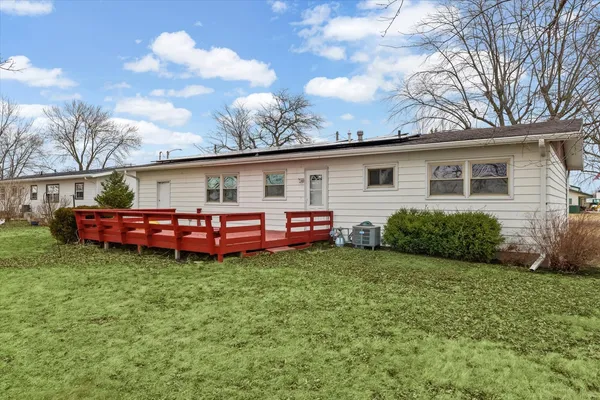 a view of roof deck with wooden floor and fence