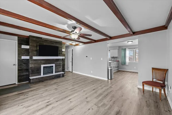 a view of a livingroom with a fireplace wooden floor and staircase