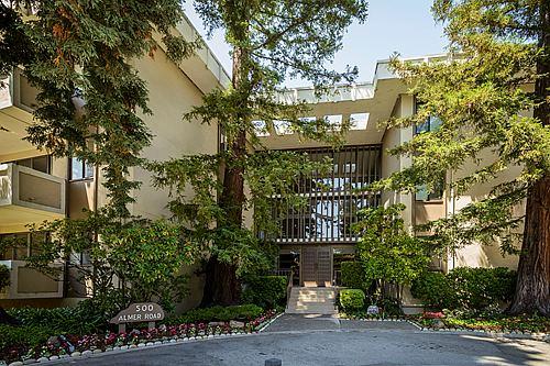 500 Almer Road, Unit 309 Burlingame, CA 94010 - Photo 1 of 20 a front view of a multi story residential apartment building with a yard and plants