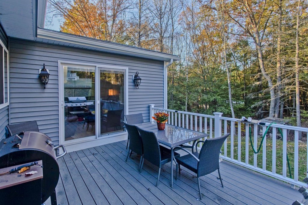 75 Moose Brook Road Southampton, MA 01073 - Photo 3 of 38 a view of a deck with table and chairs and wooden floor