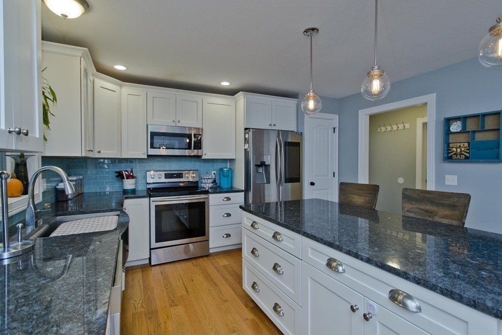 75 Moose Brook Road Southampton, MA 01073 - Photo 8 of 38 a kitchen with stainless steel appliances granite countertop a sink a stove a refrigerator a center island a dining table and chairs