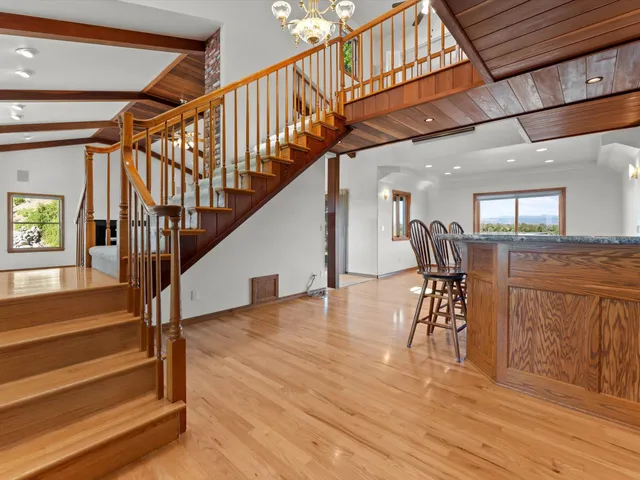 a living room with furniture and a floor to ceiling window