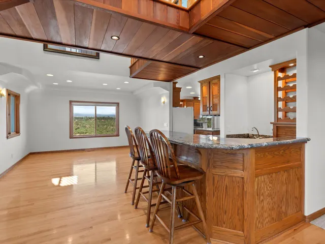 a view of a livingroom with furniture and floor to ceiling window