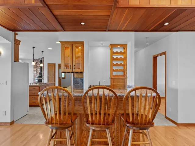 a view of a room that has wooden floor and a window