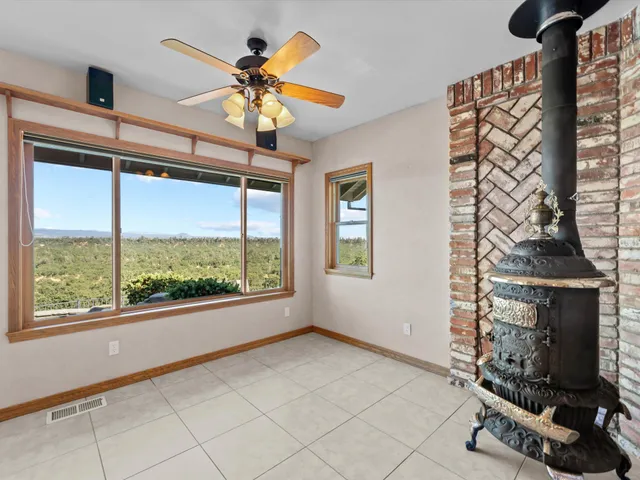 a view of a porch with wooden floor and iron stairs