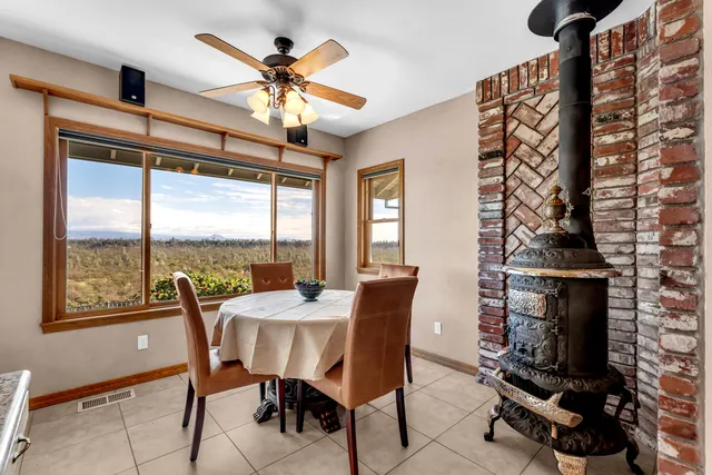 a view of a porch with a table and chairs under an umbrella
