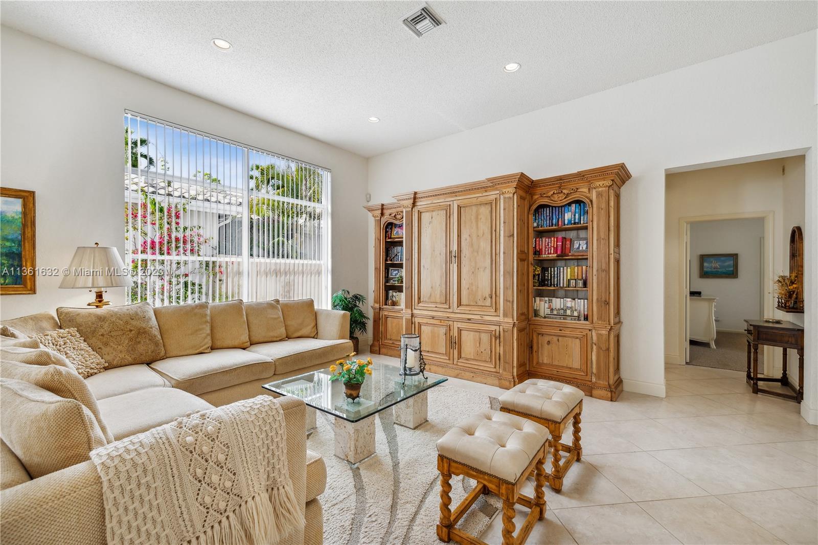 6666 Northwest 23rd Terrace Boca Raton, FL 33496 - Photo 14 of 38 a living room with furniture and a table