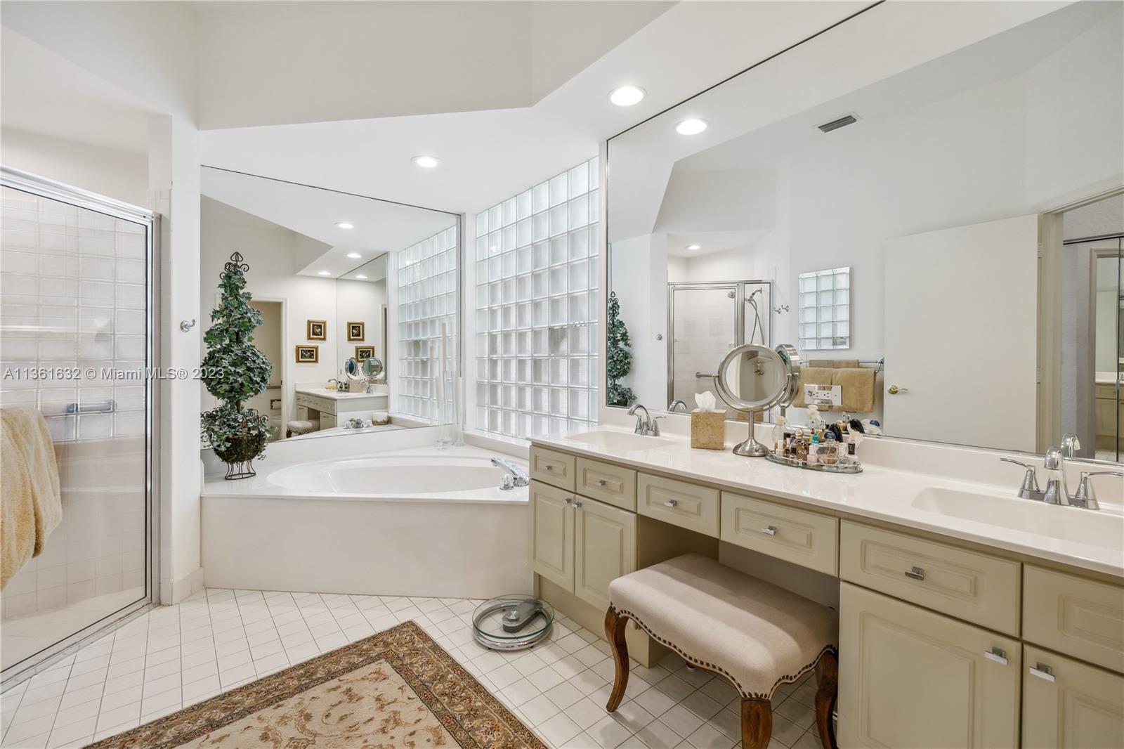 6666 Northwest 23rd Terrace Boca Raton, FL 33496 - Photo 17 of 38 a bathroom with a sink a toilet a mirror and shower