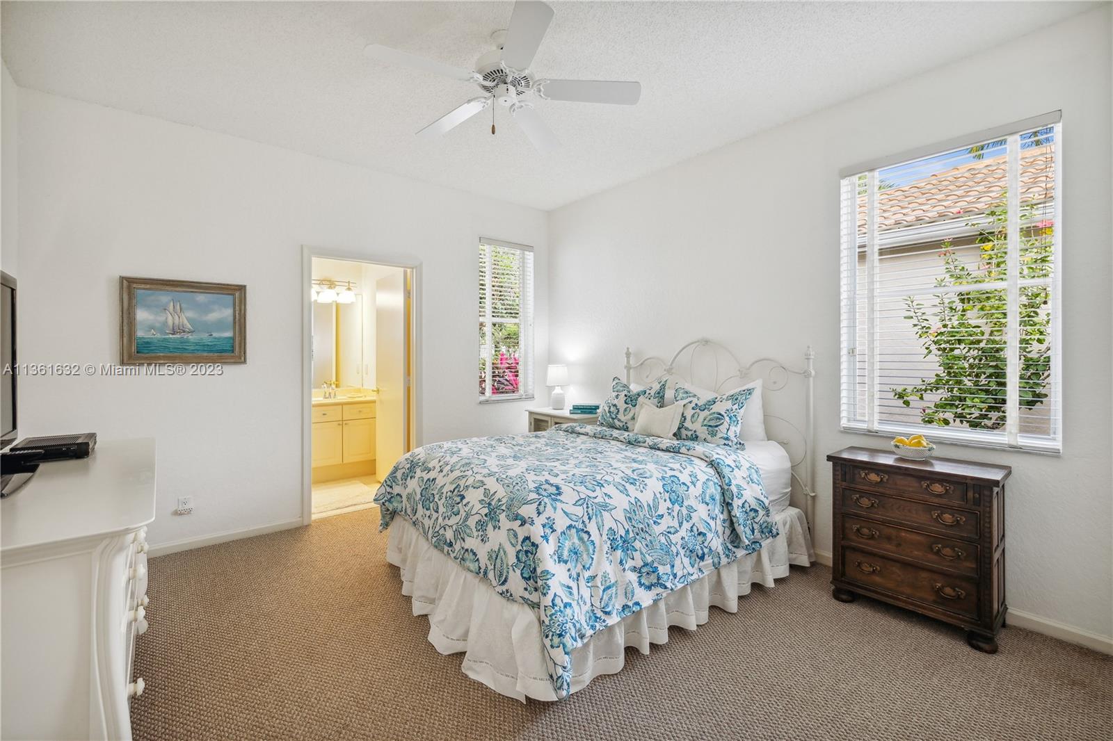 6666 Northwest 23rd Terrace Boca Raton, FL 33496 - Photo 18 of 38 a bedroom with a bed and a dresser