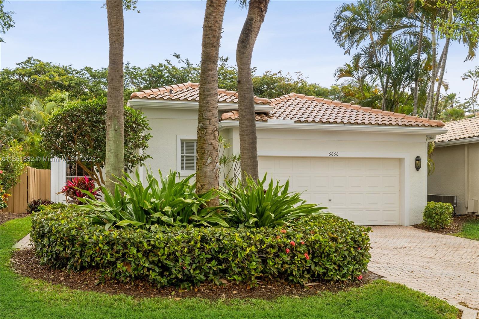 6666 Northwest 23rd Terrace Boca Raton, FL 33496 - Photo 23 of 38 a front view of a house with garden