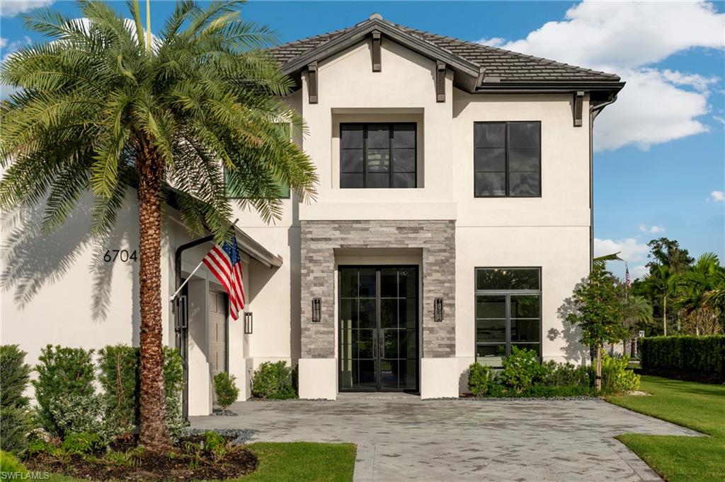 6704 Newport Road Naples, FL 34109 - Photo 3 of 47 a front view of a house with garden