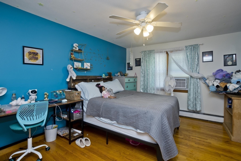 20 Maura Street Springfield, MA 01104 - Photo 18 of 41 a bedroom with a bed and a chandelier