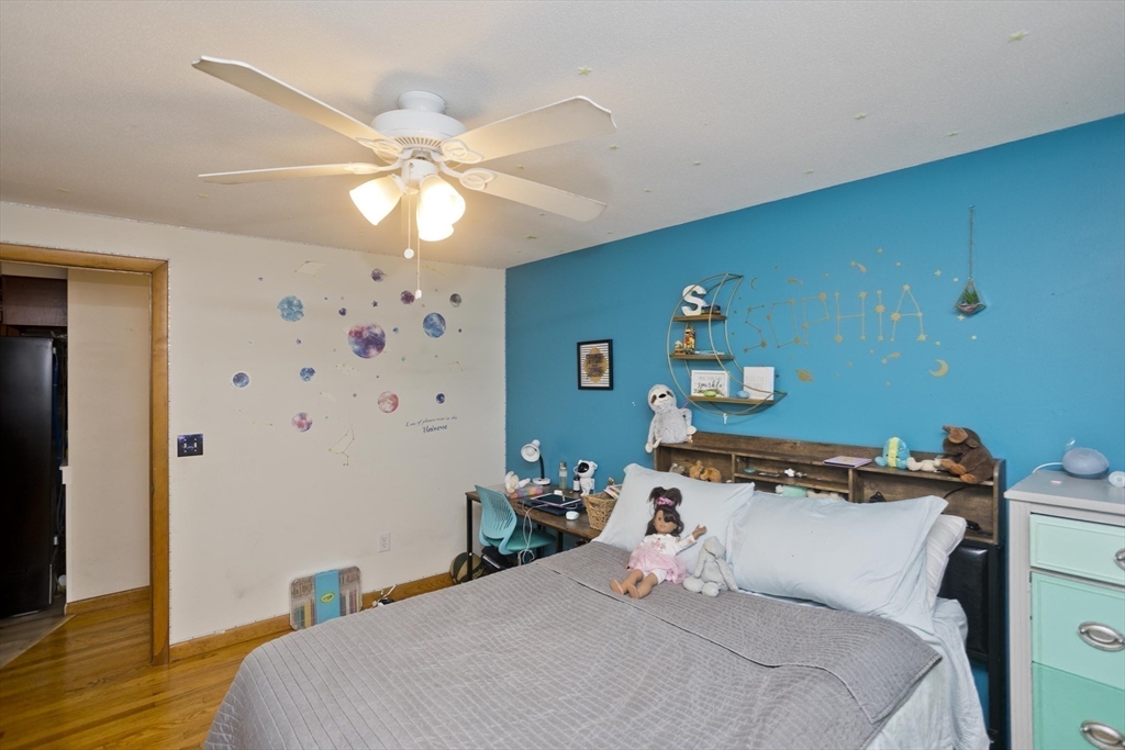 20 Maura Street Springfield, MA 01104 - Photo 19 of 41 a bedroom with a bed and a chandelier