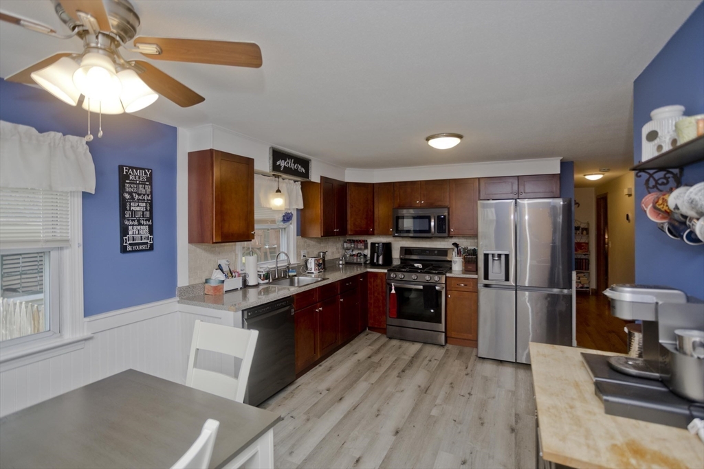 20 Maura Street Springfield, MA 01104 - Photo 9 of 41 a kitchen with refrigerator cabinets and a wooden floor