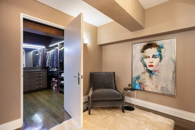 a living room with furniture and a walk in closet