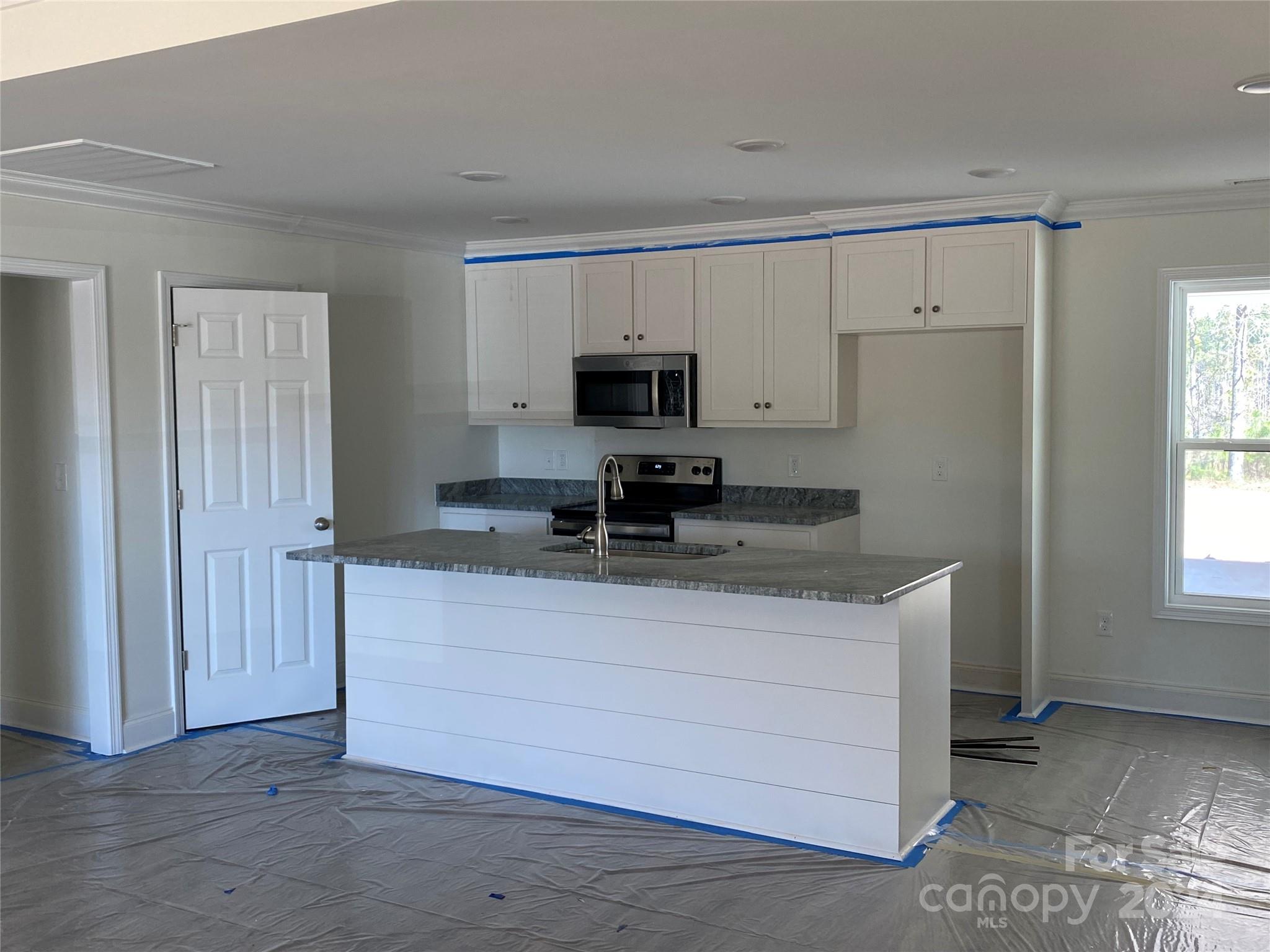 1741 Scenic View Road Hickory Grove, SC 29717 - Photo 3 of 11 a kitchen with granite countertop a sink and a stove top oven