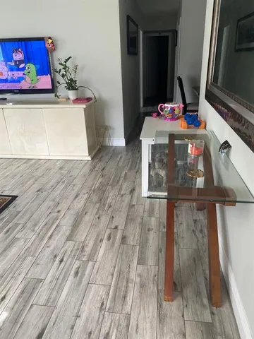 a view of a room with wooden floor