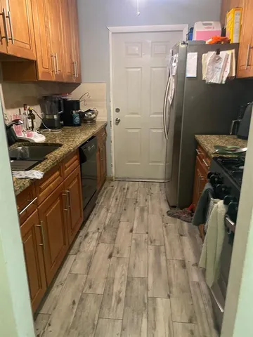 a kitchen with a sink stove and refrigerator
