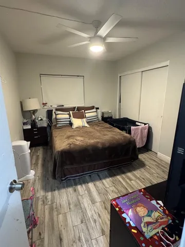 a bedroom with a bed and a mirror