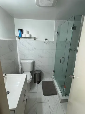 a bathroom with a toilet and a shower