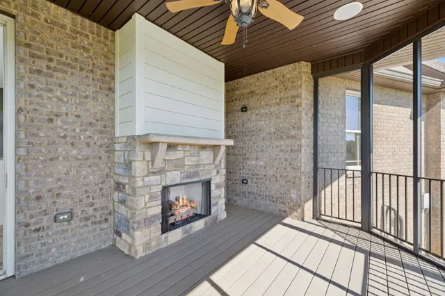 a kitchen with granite countertop a sink window and cabinets