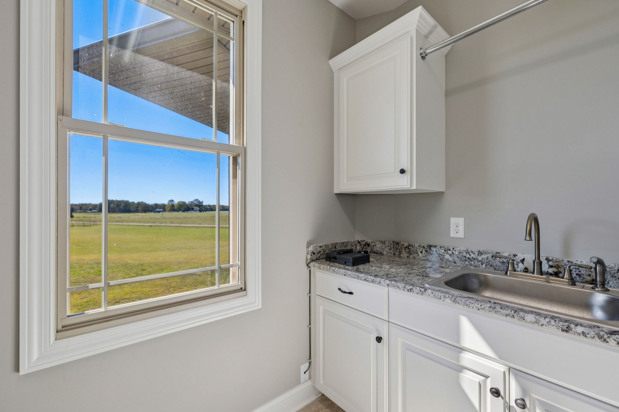 105 Barbara Spears Road Morrison, TN 37357 - Photo 19 of 55 a kitchen with granite countertop a sink window and cabinets